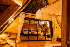 a attic room with a hammock in a house at Wild geese Lodge in Lulongo