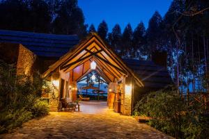 a house with a lit up entrance at night at Wild geese Lodge in Lulongo