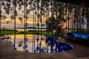 a room with a reflection of trees in a pool at Wild geese Lodge in Lulongo