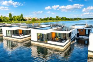 a house on the water on a river at Floatinghouse Meerkraft in Ribnitz-Damgarten