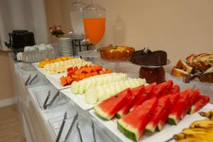 a table topped with different types of fruits and vegetables at Gru Inn Hotel in Guarulhos +7 photos