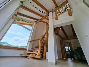 a staircase in a house with a large window at Murka Holiday Home in Bled