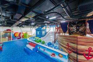 a large indoor water park with a water slide at Flamingo Cát Bà in Cat Ba