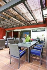 a patio with a table and chairs on a patio at Villa Salobre Master and Sun in Maspalomas