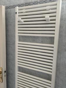a white shower door in a bathroom with a shower at Spacious Apartment 20min from Piazza Maggiore in Bologna +22 photos