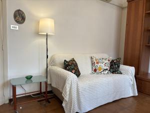 a living room with a couch with pillows and a table at Spacious Apartment 20min from Piazza Maggiore in Bologna