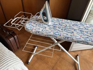a desk with a computer sitting on top of it at Spacious Apartment 20min from Piazza Maggiore in Bologna