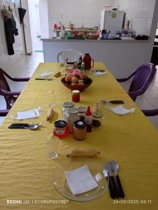 a yellow table with a bowl of fruit on it at EcoRupestre Hostel & Receptivo in São Raimundo Nonato +37 photos
