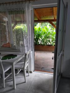 an open door to a patio with a table and chairs at Ośmiorniczka Skorzęcin in Skorzęcin