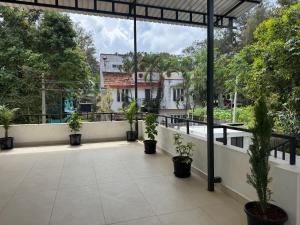 a balcony with potted plants and a building at JSP OLIVE NEST villa in Yelagiri