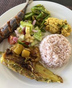 a white plate of food with rice and vegetables at Aji fruit farm cottage peaceful lakeside farm stay with sunrise views 03 in Embilipitiya