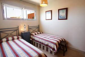 a bedroom with two beds and a window at Villa Salobre Master and Sun in Maspalomas +57 photos