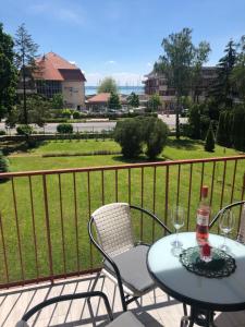 a table and chairs on a balcony with a view at Szende Apartman in Balatonfüred
