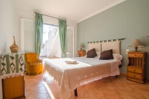 a bedroom with a large bed and a window at Na Llebrona in Porto Cristo