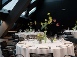a group of tables with vases with flowers on them at SO/ Vienna in Vienna +219 photos