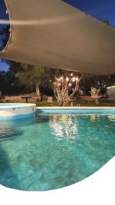 a swimming pool at night with lights at Cabaña AlpinA Ixmiquilpan in Ixmiquilpan +12 photos