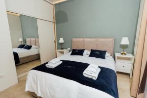 a bedroom with a large bed and a mirror at Villa Almira in Izola