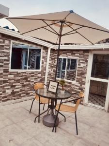 a table and chairs with an umbrella on a patio at Apartamento en Itagüí in Itagüí