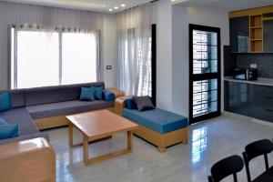 a living room with a couch and a table at Résidence saint germain in Kelibia