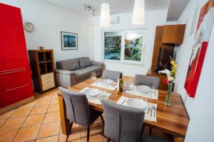 a living room with a table and chairs and a couch at Villa Almira in Izola
