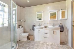 a bathroom with two sinks and a toilet and a shower at 2 Bed in Devizes oc-t43754 in Bulkington +32 photos