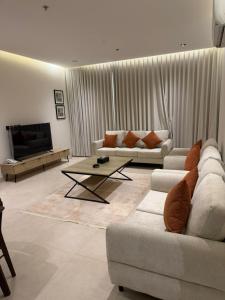 a living room with two couches and a coffee table at ايا ان AYA Inn in Jeddah