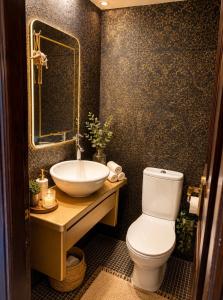 a bathroom with a white toilet and a sink at Marsia House in Vathí
