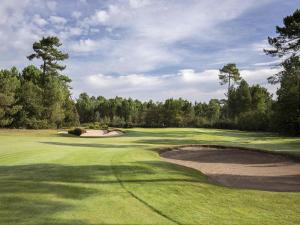 a view of a golf course with a green at Cabot Hotel Bordeaux - MGallery Collection in Le Pian-Médoc