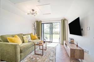 a living room with a couch and a tv at 1 Bed in Stewarton oc-c44699 in Stewarton
