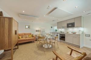 a kitchen and living room with a couch and a table at 1 Bed in Stewarton oc-c44699 in Stewarton