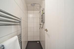 a small bathroom with a shower and a toilet at 1 Bed in Stewarton oc-c44699 in Stewarton +18 photos