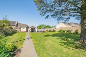 a driveway leading to a house with a grass yard at 1 Bed in Stewarton oc-c44699 in Stewarton