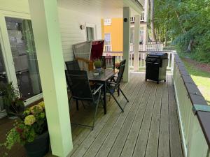 a deck with a table and chairs on a house at Ferienwohnung W18 0 N in Graal-Müritz +9 photos
