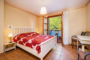 a bedroom with a bed and a table and a window at Cala Pi One in Cala Pi