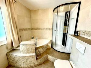 a bathroom with a shower and a bath tub at Auszeit im Grünen in Gailitz +29 photos