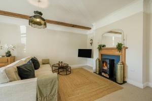 a living room with a couch and a fireplace at 2 Bed in Blythburgh oc-w42765 in Blyford