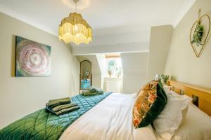 a bedroom with a bed and a chandelier at 2 Bed in Blythburgh oc-w42765 in Blyford +13 photos