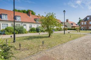 a park with a tree in the middle of a street at 2 Bed in Blythburgh oc-w42765 in Blyford