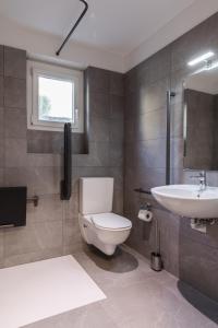 a bathroom with a toilet and a sink at By THE LAKE in Muralto +24 photos