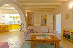 a living room with a couch and a table at Villa Verde Petra in Rethymno