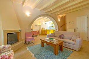 a living room with a couch and a table at Villa Verde Petra in Rethymno