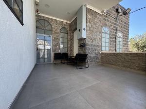 a patio with a table and chairs in a building at City Stay Tiberias - סיטי סטיי טבריה in Tiberias