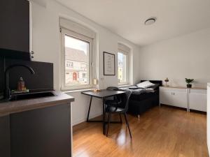 a kitchen and living room with a table and a couch at GWP Apartments in Lohmar