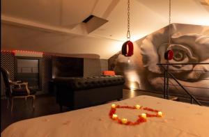a room with a couch and a table with lights on it at Ruelle Sensuelle in Ruelle-sur-Touvre