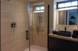 a bathroom with a glass shower and a sink at Ruelle Sensuelle in Ruelle-sur-Touvre