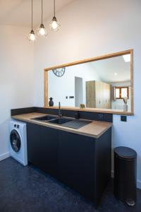a kitchen with a sink and a washing machine at L'écrin de St Antoine in Saint-Antoine +76 photos