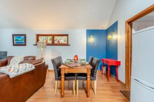 a living room with a table and a couch at 2 Bed in St. Fillans oc-a40242 in Saint Fillans