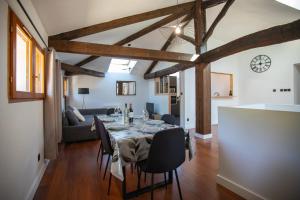 a dining room with a table and chairs at L'écrin de St Antoine in Saint-Antoine