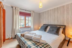 a bedroom with a bed and a window at 2 Bed in St. Fillans oc-a40242 in Saint Fillans