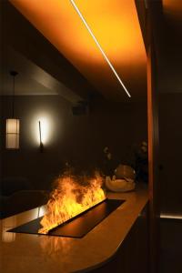a fire pit in a living room with a table at Best Western Plus John Bauer Hotel in Jönköping
